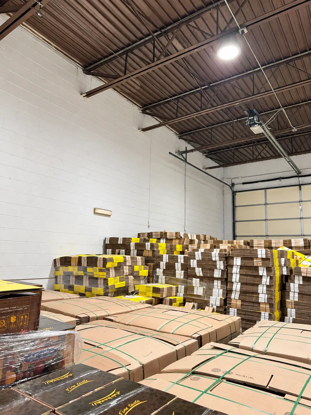 Stacked cartons of inventory staged for shipment inside the Garden City warehouse